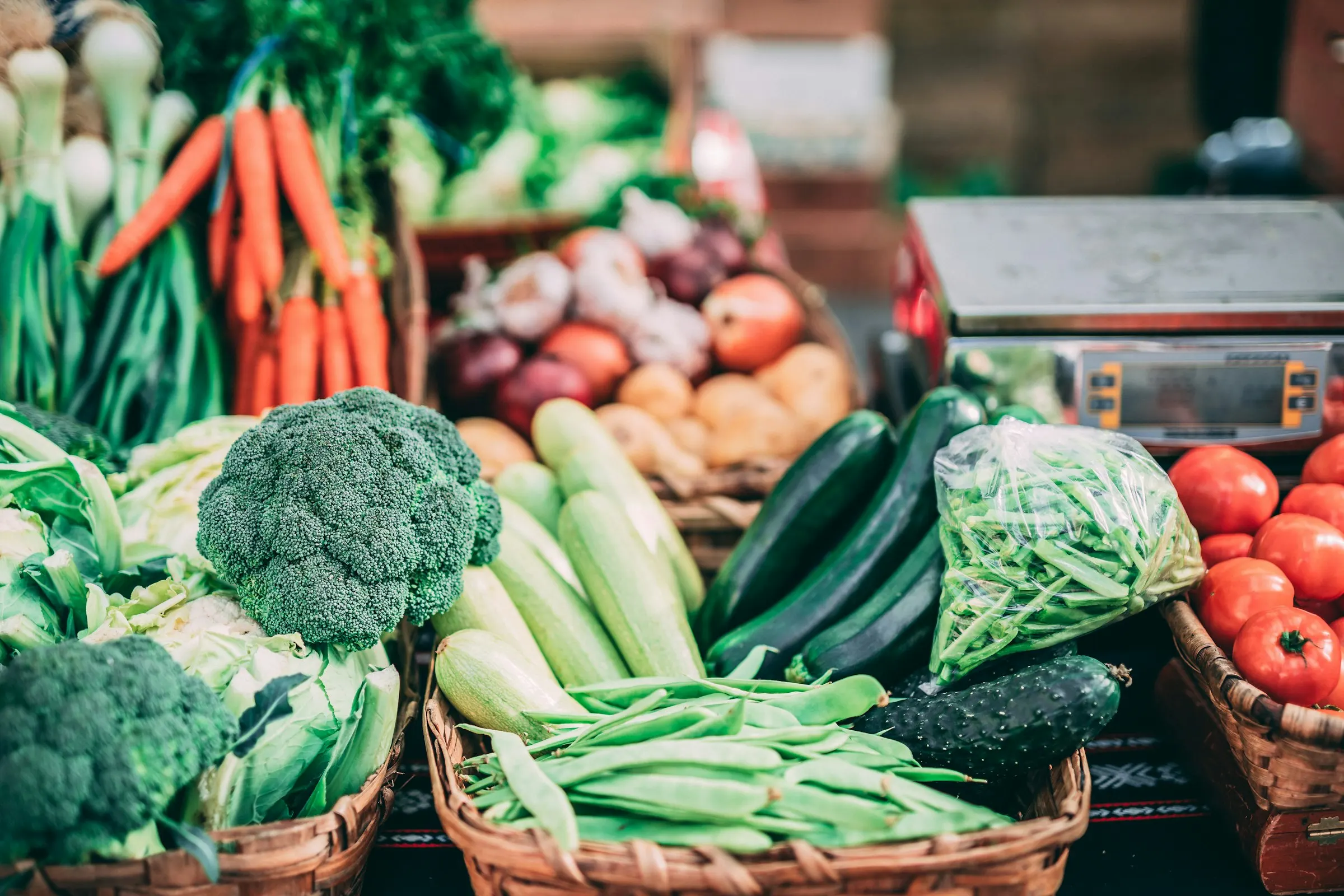 Baskets of freshly harvested vegetables at a farmers' market